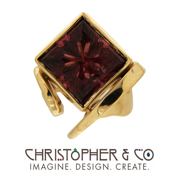 CMJ E 21084   Gold ring set with concave cut rubellite tourmaline handcut by Richard Homer, designed by Christopher M. Jupp.