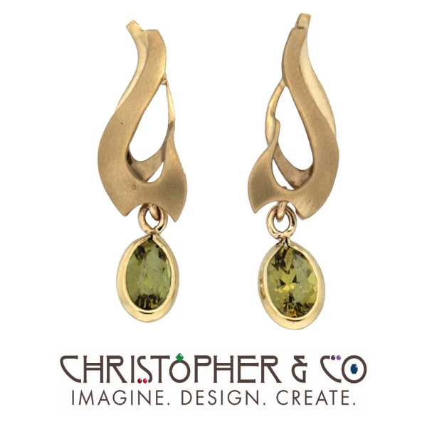 CMJ R 13012    Gold earring pair set with Mali garnets designed by Christopher M. Jupp.