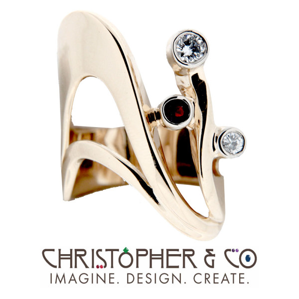 CMJ R 13112    Gold ring set with diamonds and garnet designed by Christopher M. Jupp.