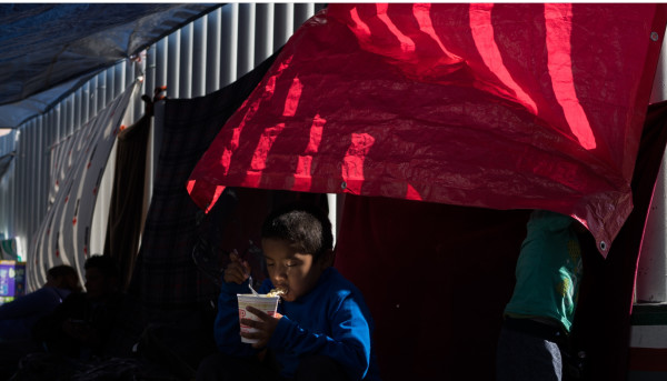 Jeancarlos from Guatemala, age 6, at a makeshift encampment where he has been waiting with his mother and brother to seek asylum in the U.S., in Tijuana, México by Verónica G. Cárdenas