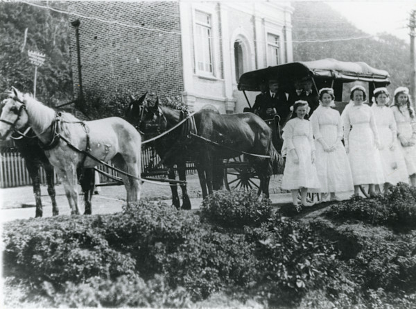 Girls in white dresses in front of Clifton School of Arts
