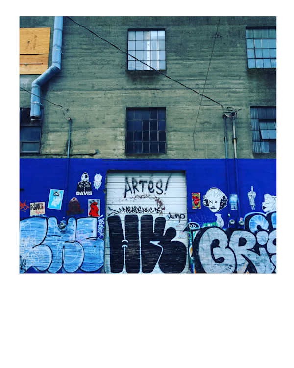 Gray Building Blue Graffiti by Chris McMurry