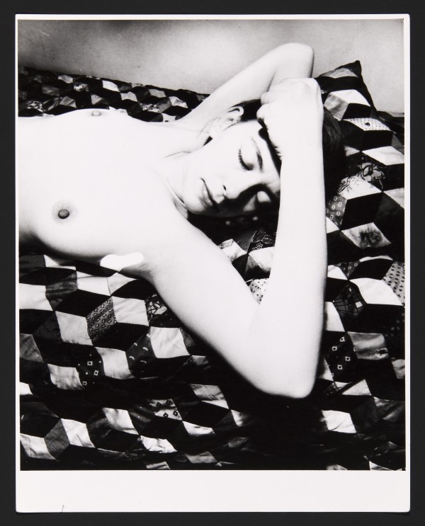 Black and white photograph of a sleeping nude female torso by Bill Brandt