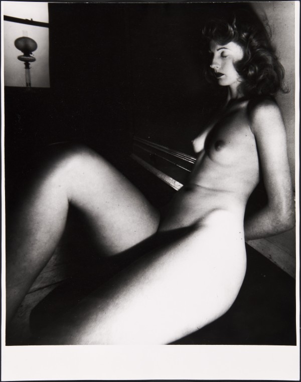 Black and white photograph of a sitting nude female by Bill Brandt