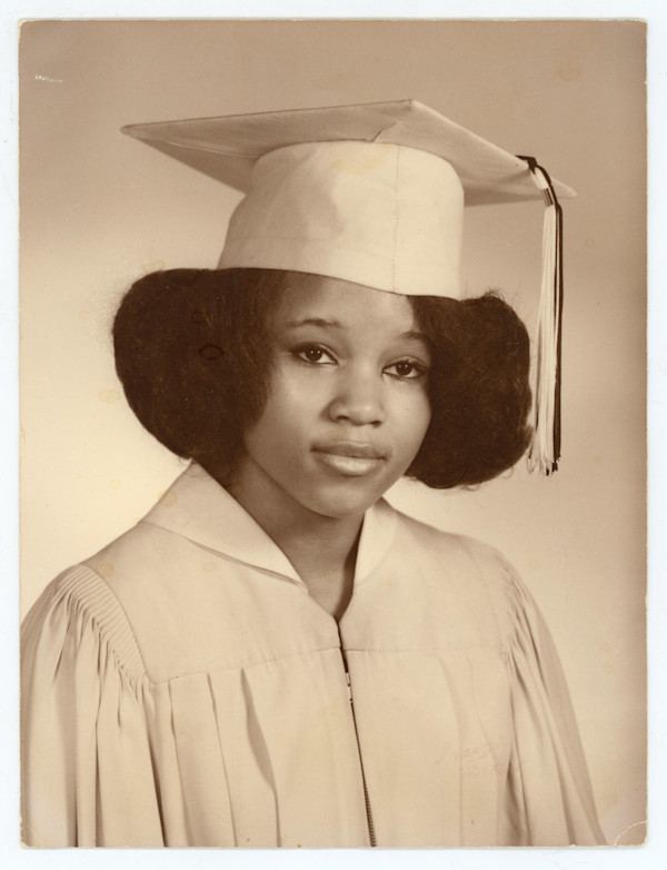 Woman with puffy hair in cap & gown by Unknown