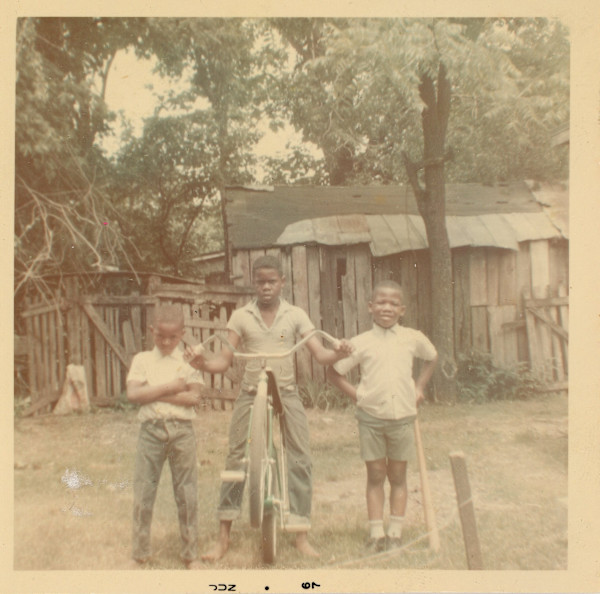 Three boys and bike by Unknown