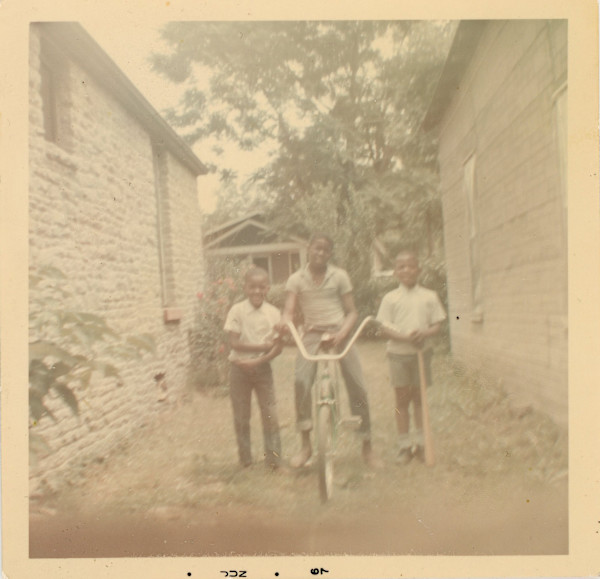Three boys and bike by Unknown