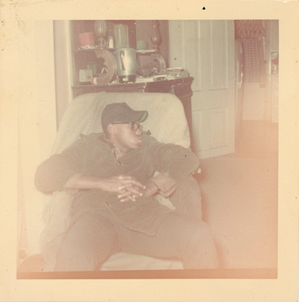 Young man sleeping in chair by Unknown