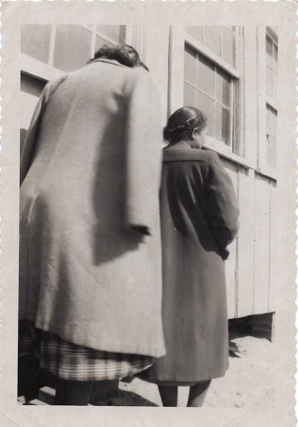 Two women walking seen from behind by Unknown
