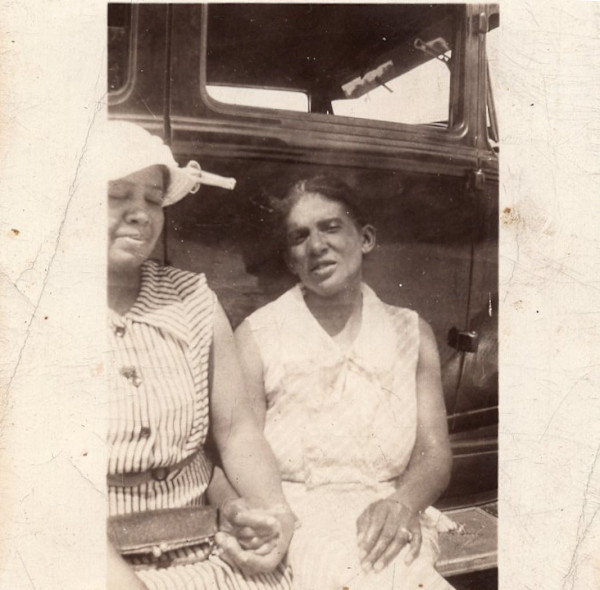 Two women holding hands by Unknown
