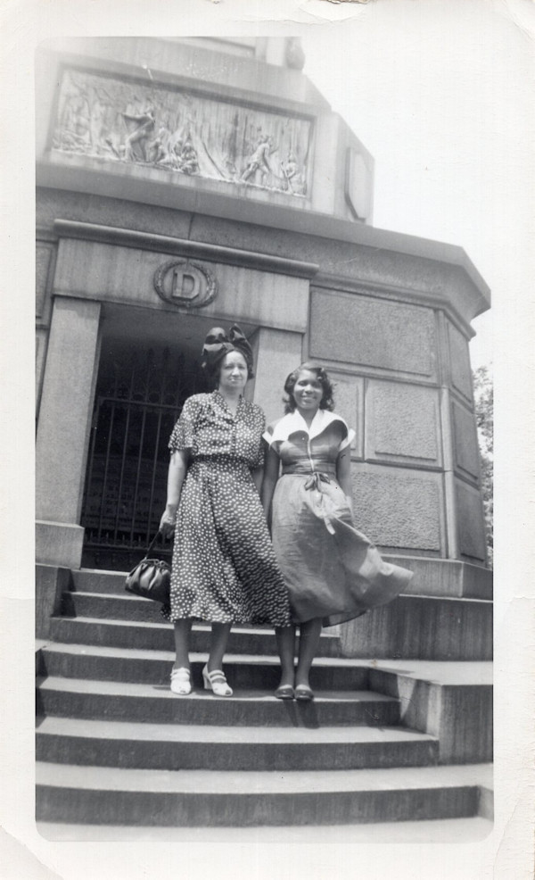 Two women standing on monument steps by Unknown