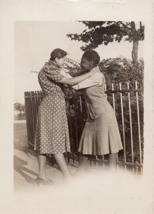 Two women play wrestling by Unknown