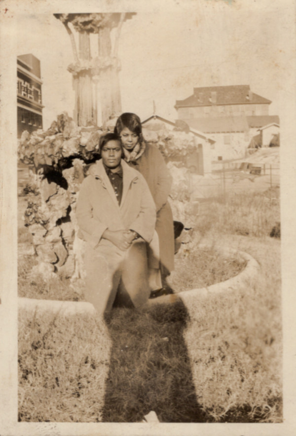 Two women in garden with photographer's shadow by Unknown