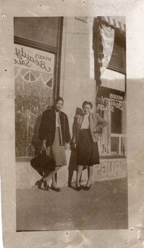 Two women standing outside Woods Beauty Salon by Unknown