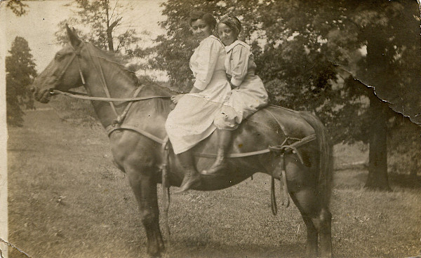 Two girls on horseback by Unknown