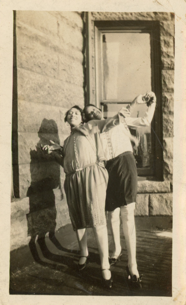 Two women playfully posing by Unknown
