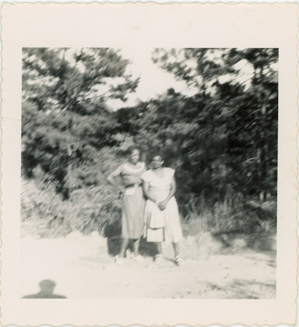 Two women with photographer’s shadow by Unknown