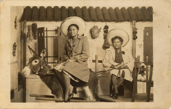 Two women, one burro by Unknown