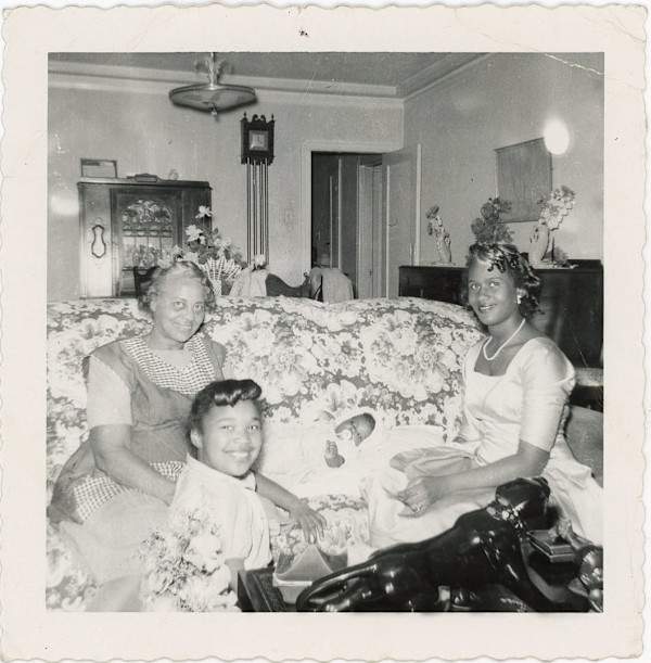 Two women, a girl, & a baby by Unknown