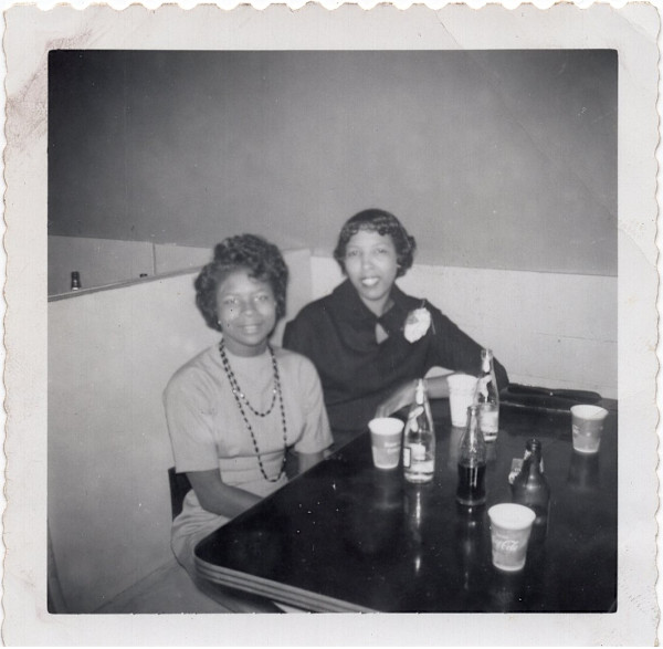 Two women in restaurant booth by Unknown