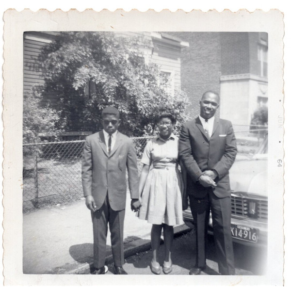 Trio standing in front of car by Unknown