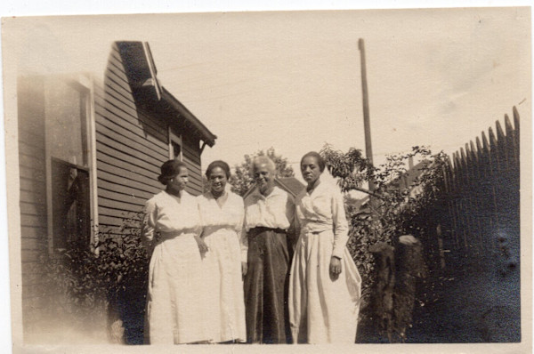 Four women by the house by Unknown