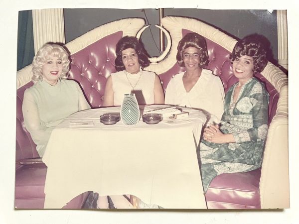 Four women in booth by Unknown