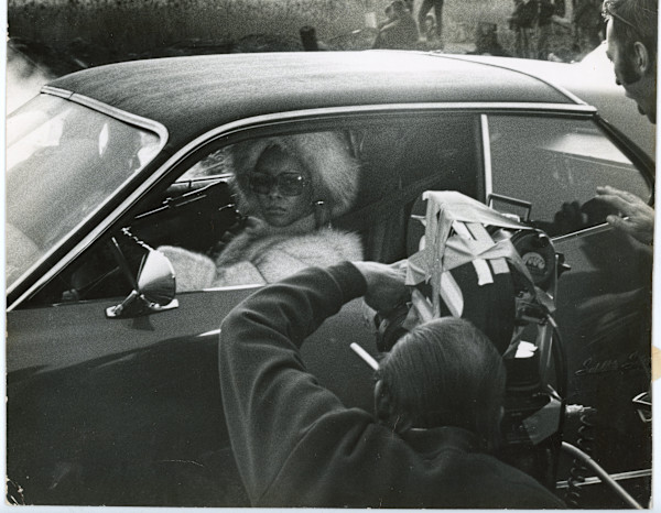 Actress in car being filmed by Unknown