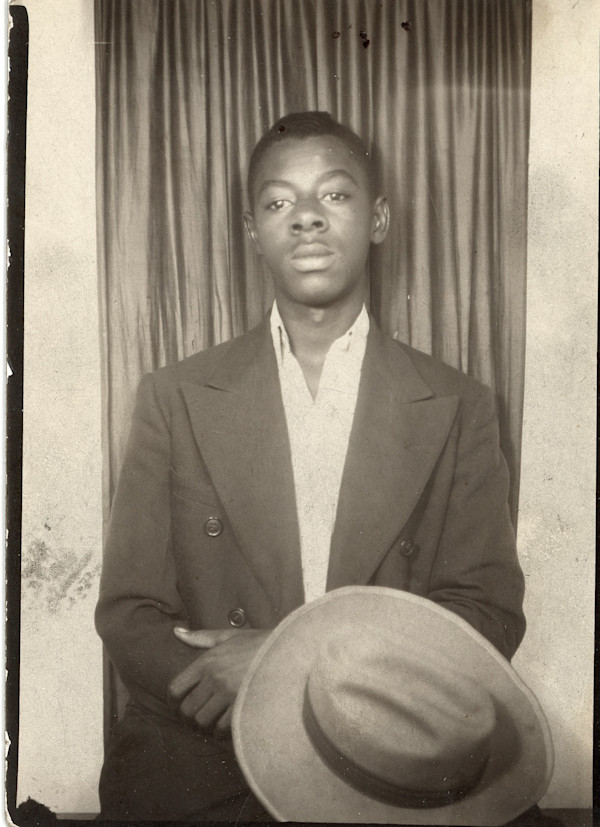 Man holding his hat by Unknown