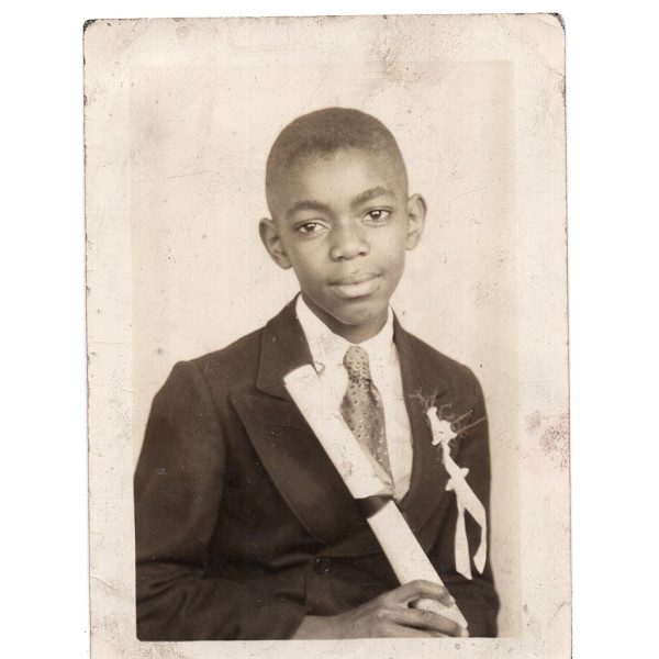 Boy holding diploma by Unknown