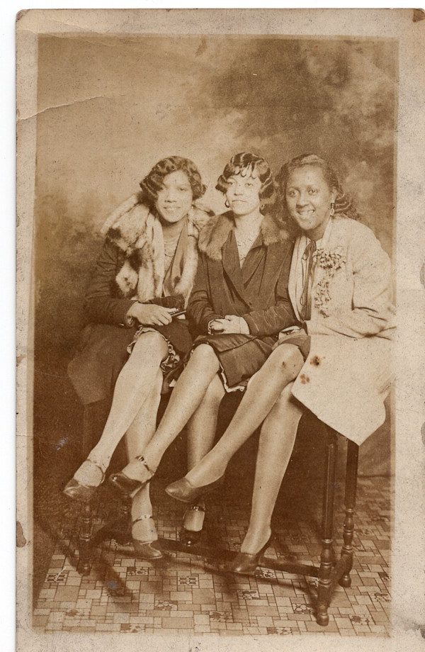 Three women with crossed legs by Unknown