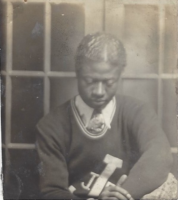 Young man in letterman sweater by Unknown