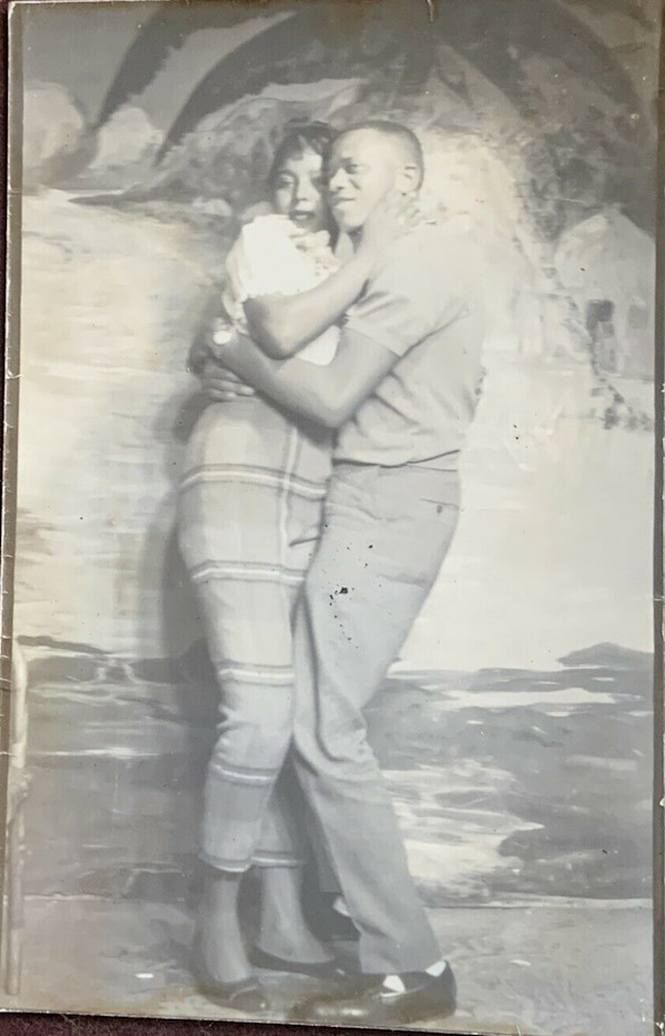 Affectionate couple against tropical backdrop by Unknown