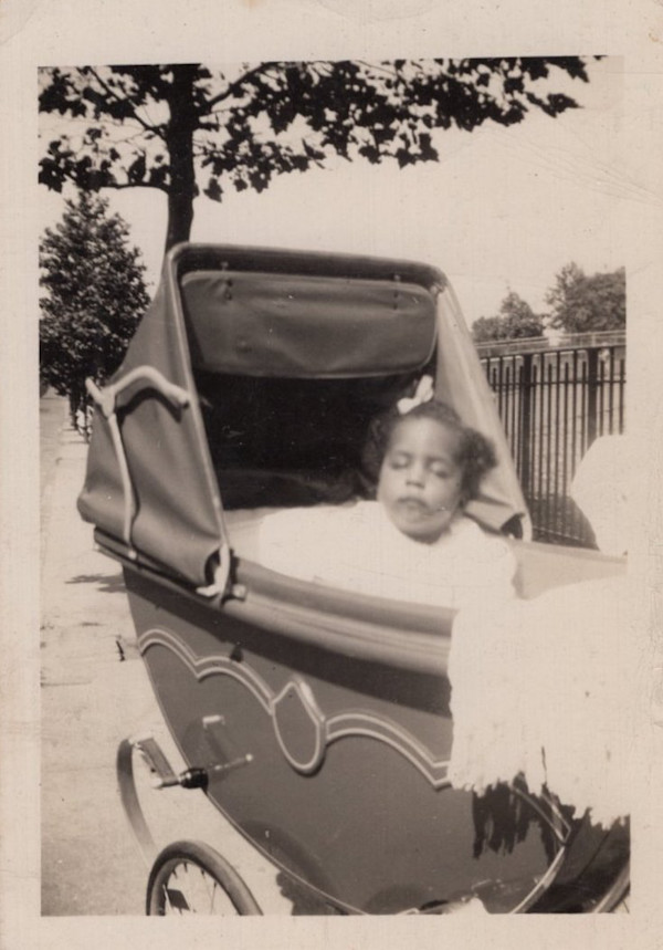 Girl in stroller by Unknown