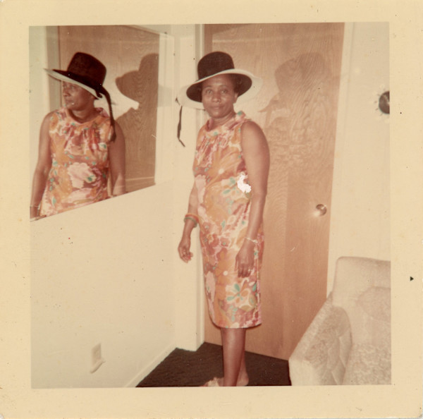 Woman in black hat reflected in mirror by Unknown