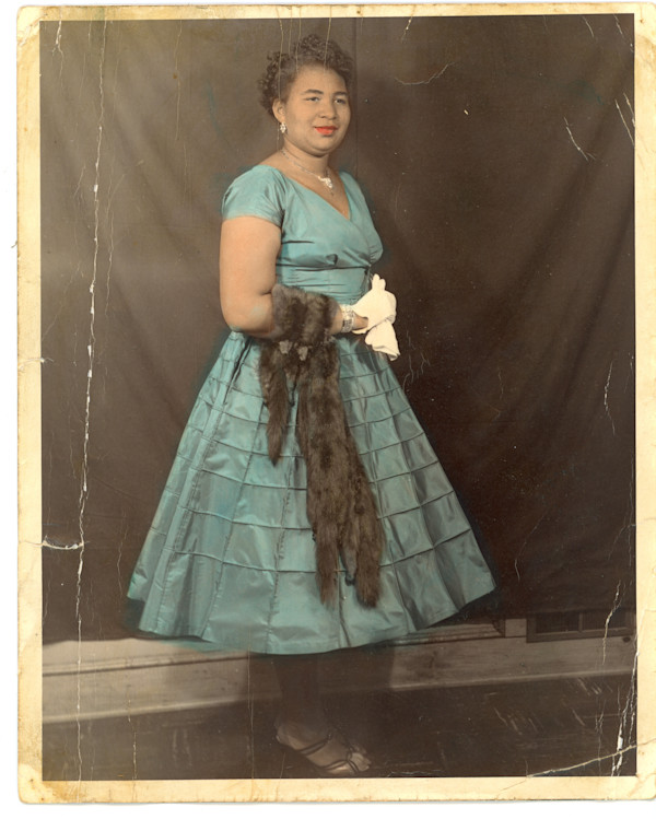 Woman in blue dress with fox stole by Unknown