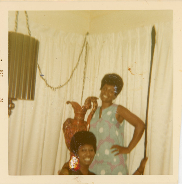 Woman in blue dress and friend by Unknown