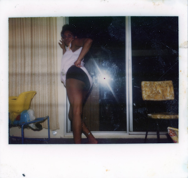Woman vamping with camera flash in window by Unknown