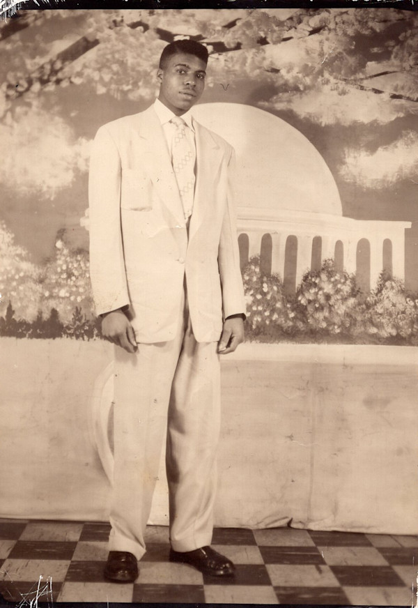 Young man on checkerboard floor with cherry blossoms and Jefferson Memorial backdrop by Unknown