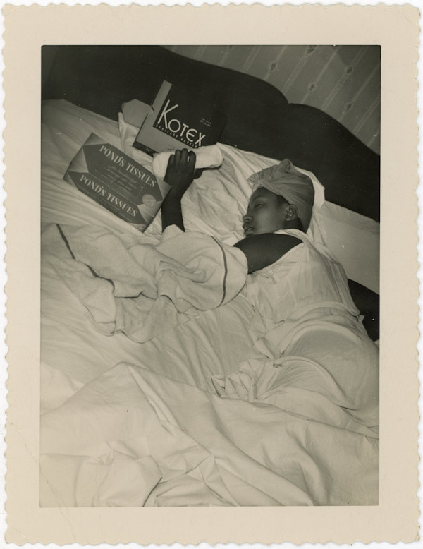 Woman in bed with Kotex and Pond's tissues boxes by Unknown