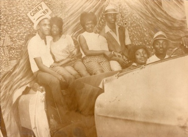 Three couples in prop car with Coney Island sign by Unknown
