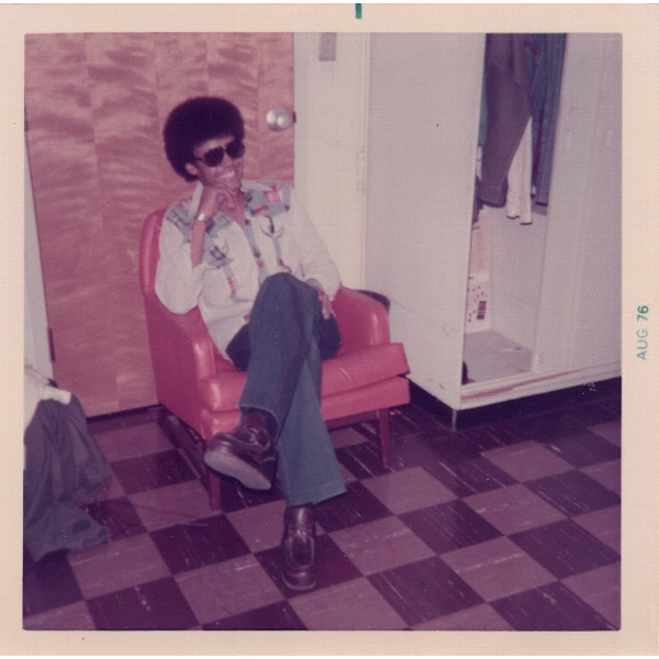 Seated man with Afro by Unknown