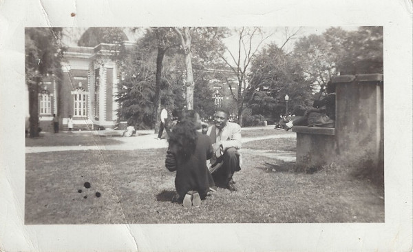 Coeds kneeling on campus lawn by Unknown