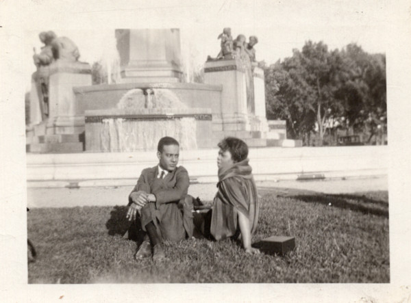 Couple sitting near fountain by Unknown