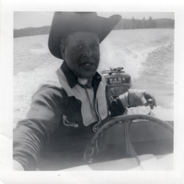 Man in cowboy hat on a boat by Unknown