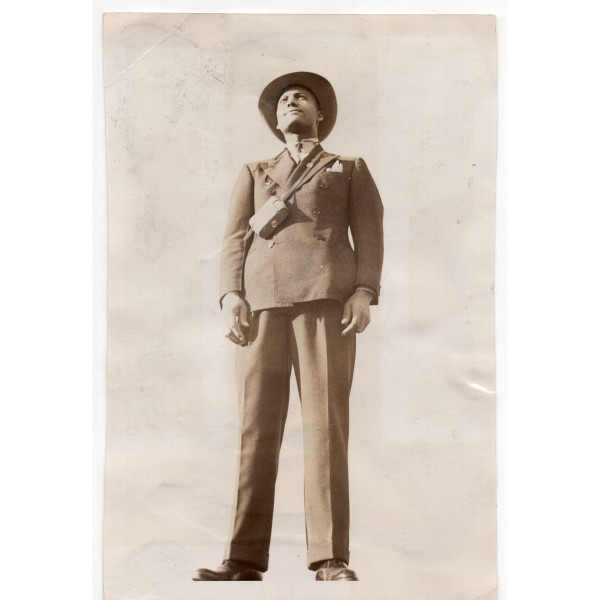 Man in suit with strapped-on camera by Unknown