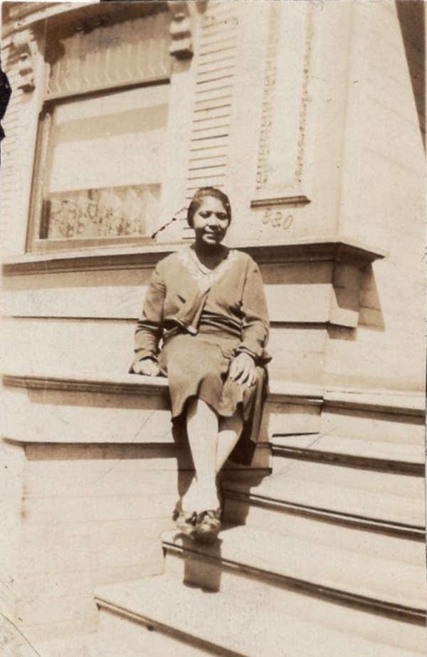 Woman with legs crossed at the ankles by Unknown