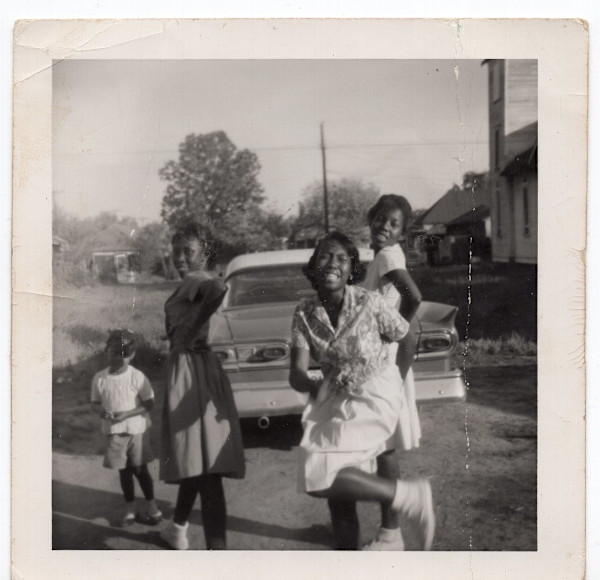 Cynthia and friends cavorting in the street by Unknown