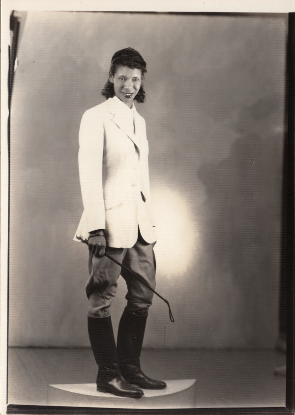 Equestrian woman with riding crop by Unknown