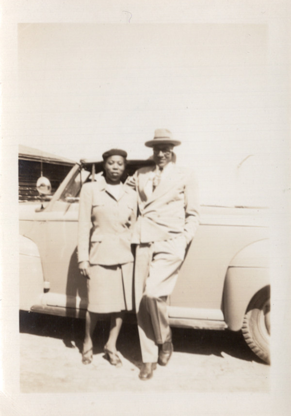 Couple next to car by Unknown